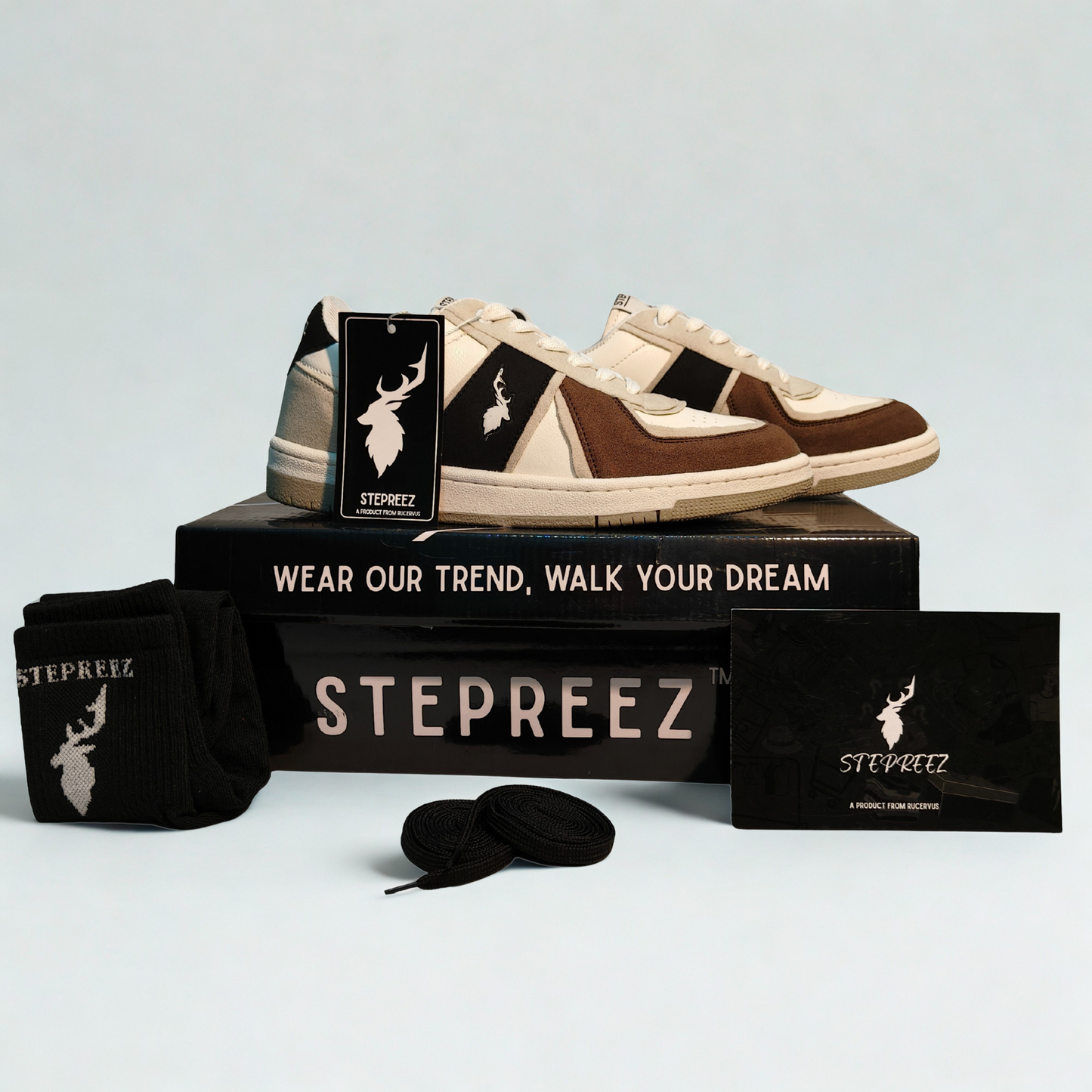Complete unboxing view of brown,  black, stone-gray and white casual sneakers with branded box, socks, and extra laces.